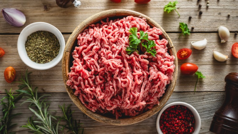 ground beef in bowl with seasonings