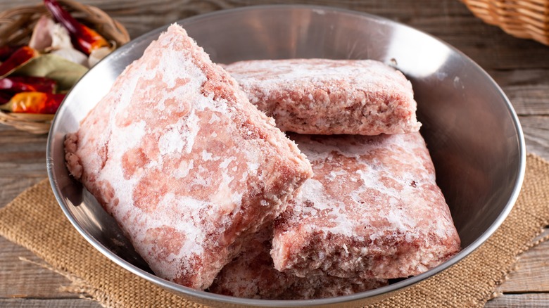 Frozen ground beef in bowl