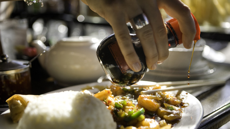 Pouring soy sauce on food