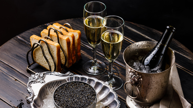 Champagne served in flutes with toast and caviar on the side