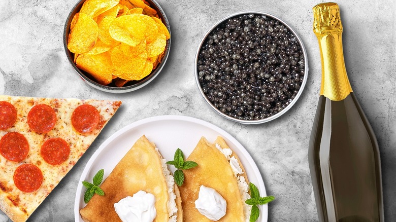 Bowl of caviar alongside several other foods