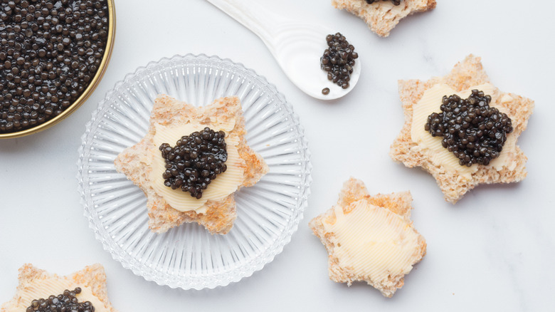 Soft bread spread with butter and topped with caviar