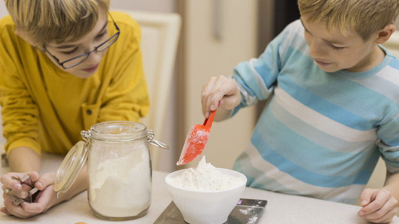 boys weighing flour