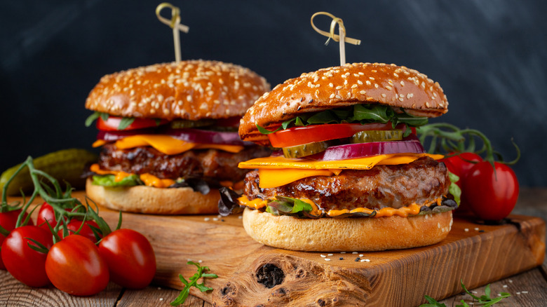 Burgers on wooden cutting board