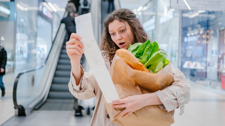 Person looking at grocery receipt