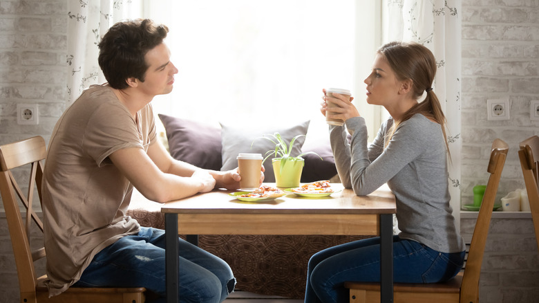 Couple drinking coffee and eating