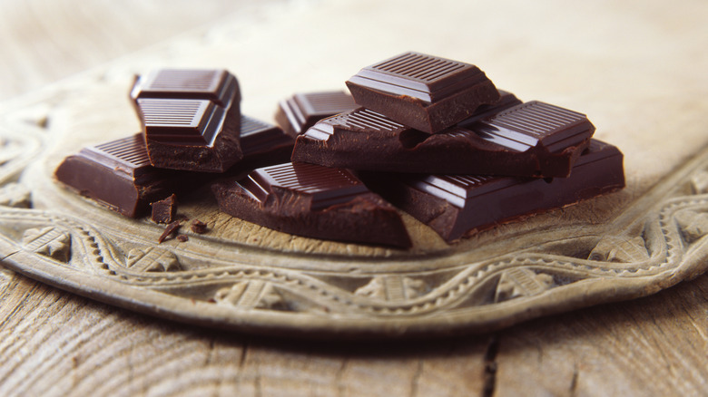 Dark chocolate squares on a fancy wooden tabletop