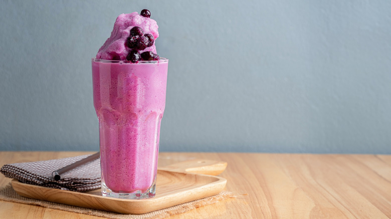 Overfilled pink frozen smoothie with fresh berries