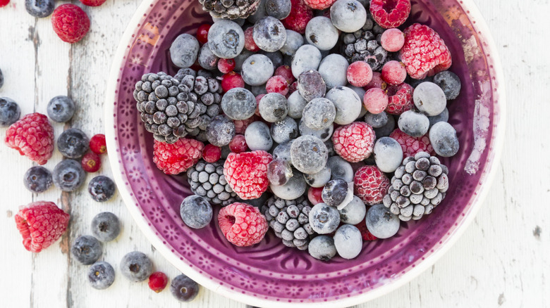 A bowl of frozen blueberries, blackberries, raspberries, and currants