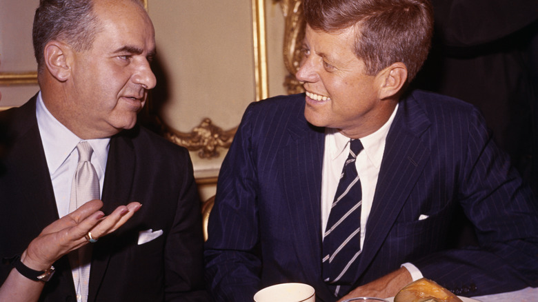 JFK at a dining table with a guest