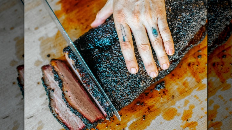 Aerial of hand slicing brisket from La Barbecue