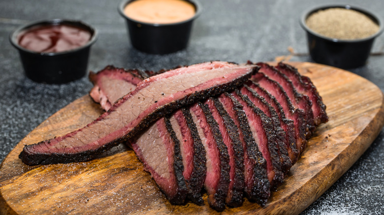 Platter of beef brisket on wooden surface