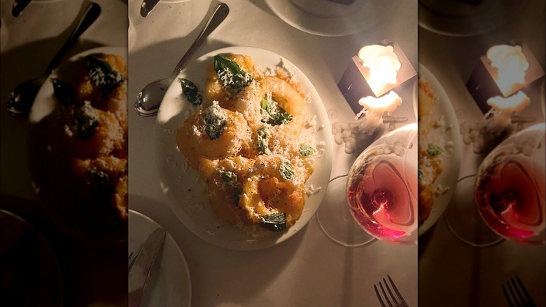 Fried delicata squash, wine, and candle on table at Borgo