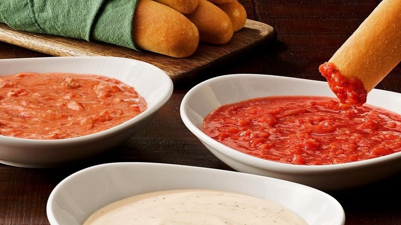 Breadstick dipping in sauce