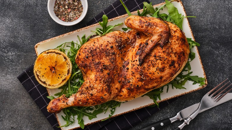 Half roast chicken with arugula