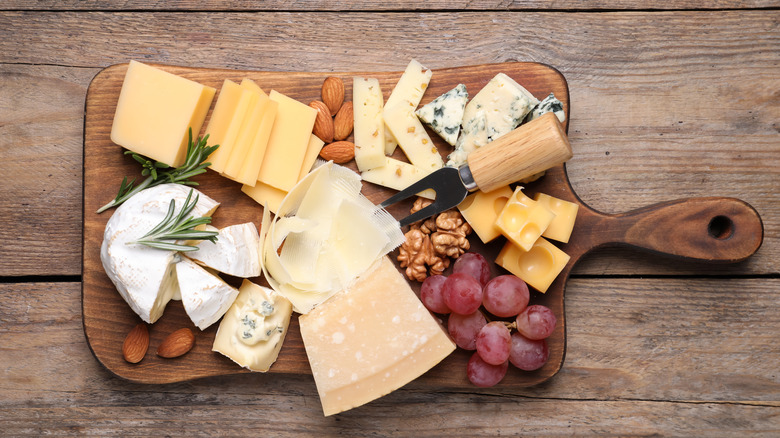 various cheeses on wooden board