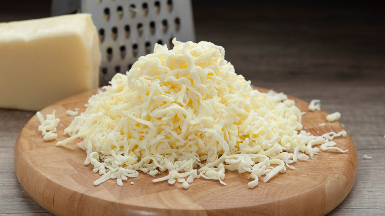 Grated cheese on cutting board