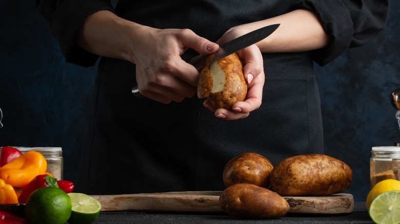 Peeling potato with chef's knife