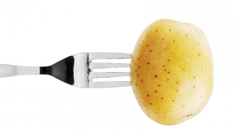 Fork stuck into potato