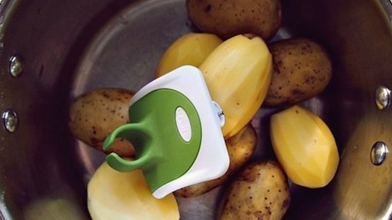 Palm peeler with potatoes