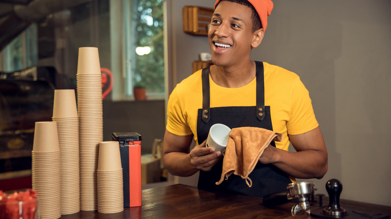 barista cleaning with microfiber cloth