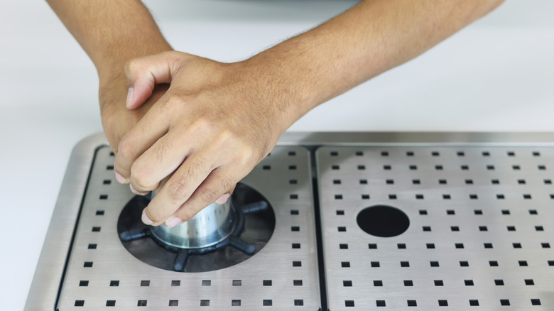 barista using pitcher rinser