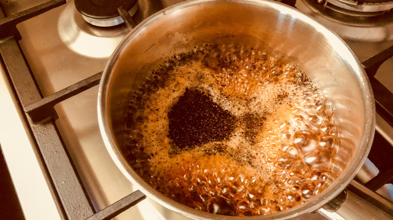 Overhead image of tea boiling in a vessel