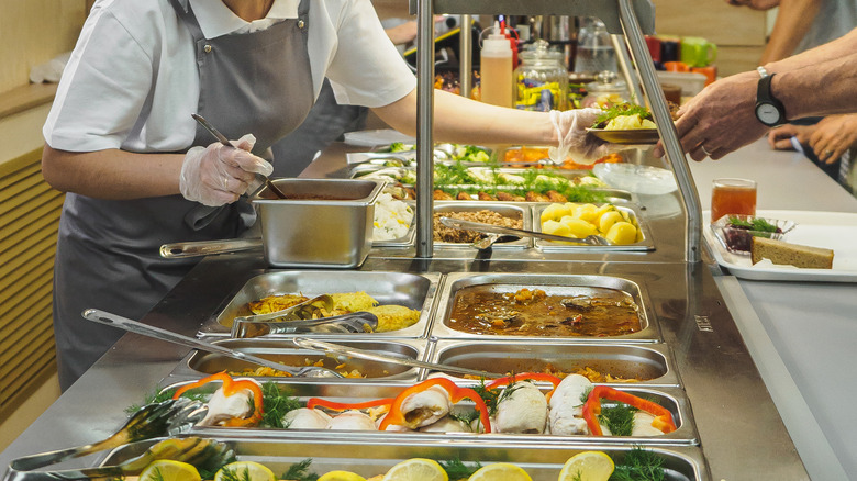 server helping at a buffet