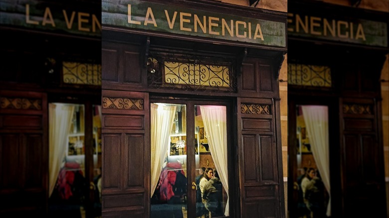 Extrerior of La Venencia with open window and diners