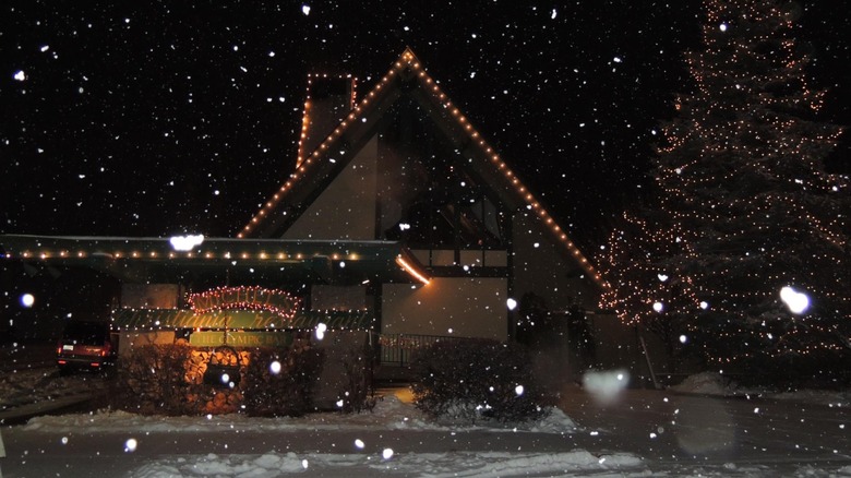 Michel's Christiania exterior on a snowy night with holiday decorations