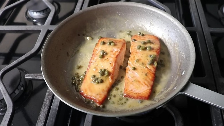 Cooking salmon piccata in frying pan