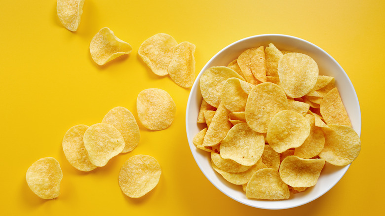 potato chips bowl yellow background