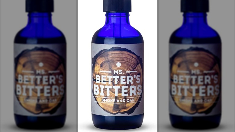 Close-up of a blue bottle of Ms. Better's Bitters Smoke and Oak Bitters