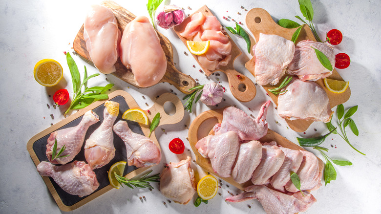 chicken pieces portioned on chopping boards