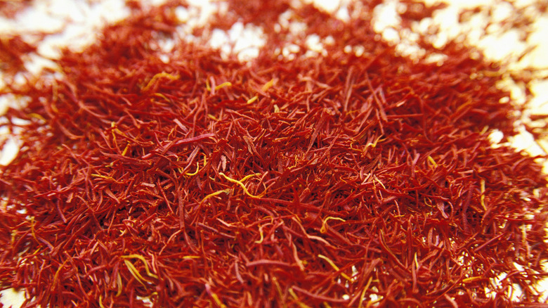 Saffron gives dishes a typical yellowish tinge although the saffron threads are an orangy red when uncooked.