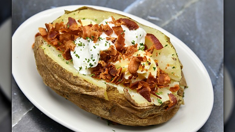 A loaded baked potato on a plate