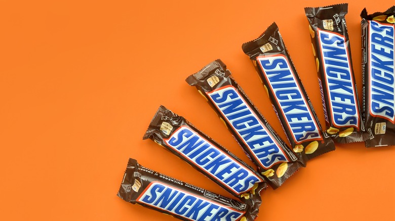 Snickers bars on orange background