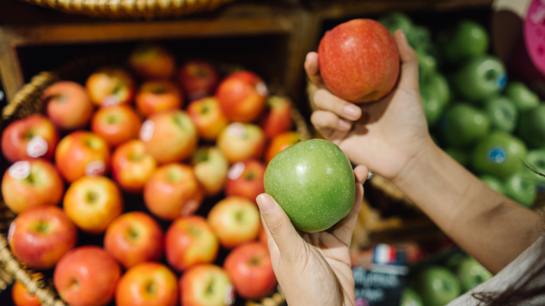 Hands holding apples