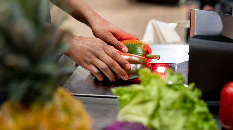 Person scanning peppers