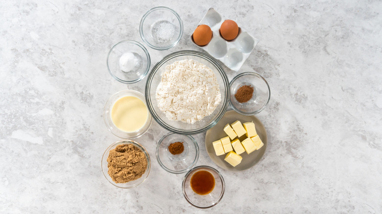 Eggnog ingredients are measured out in bowls and shown in an overhead view.