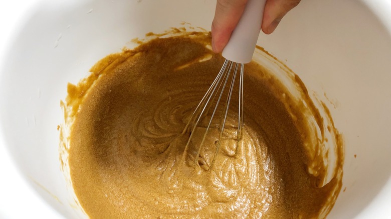 Mixing pumpkin batter with whisk