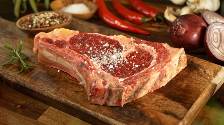 raw steak on cutting board