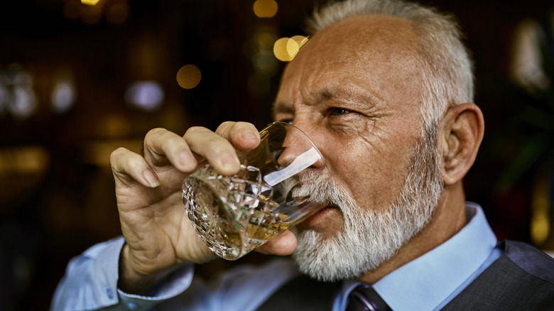 person sipping bourbon