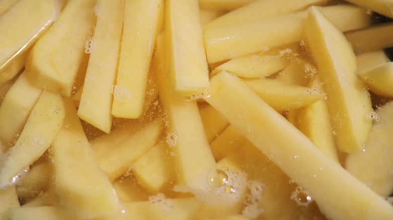 French fries soaking in water