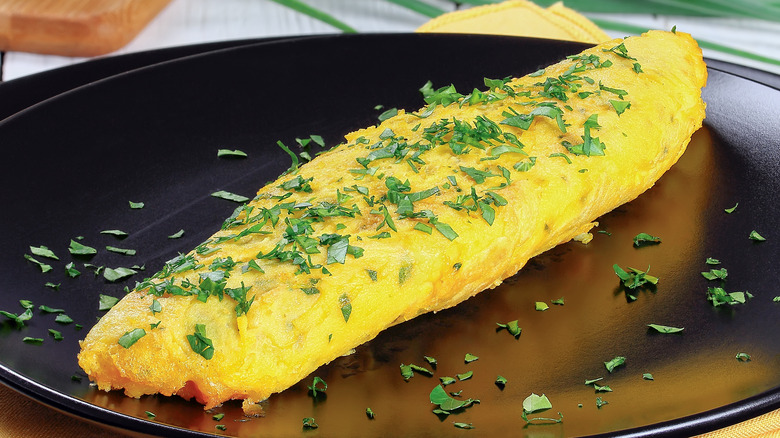 French omelet on black plate