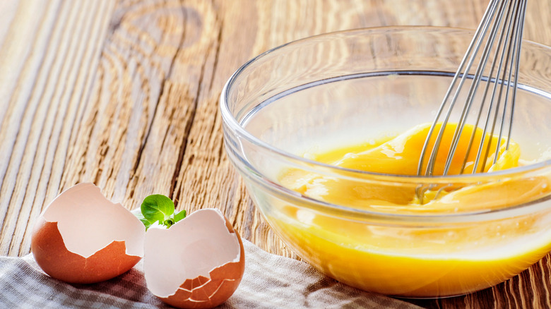 Whisking eggs in glass bowl