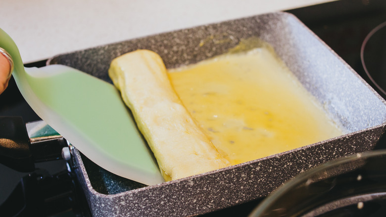 Cooking tamagoyaki in pan