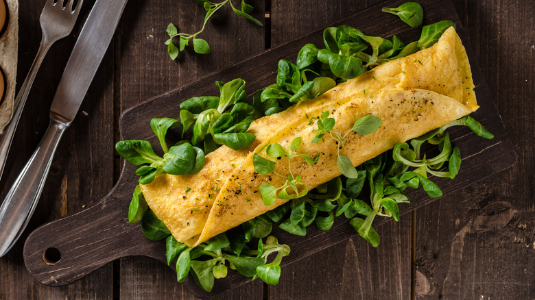 Omelet with herbs on board