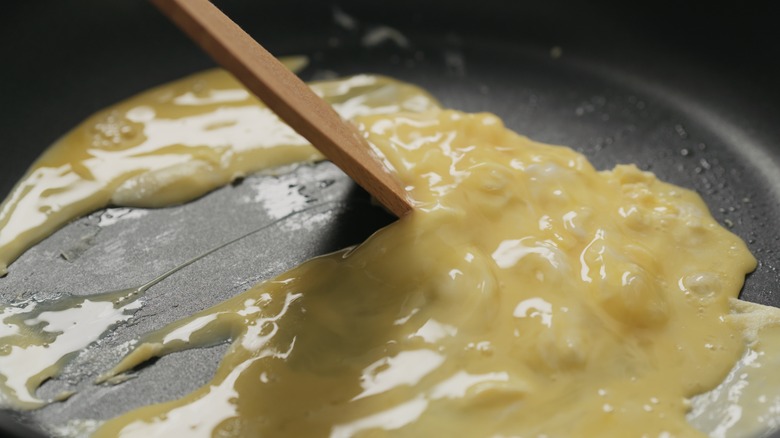 Stirring omelet in pan