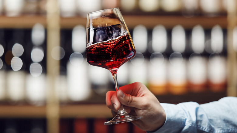 Hand swirling a glass of red wine